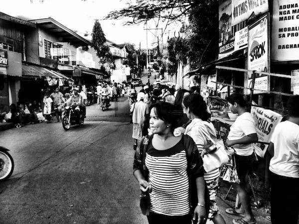 Black and white photo of people in a city.