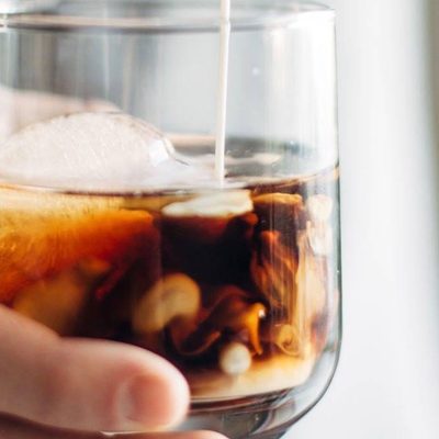 Cinnamon White Russian in a glass with cream.