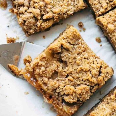 Caramel Apple Crisp Bars sliced with spatula.