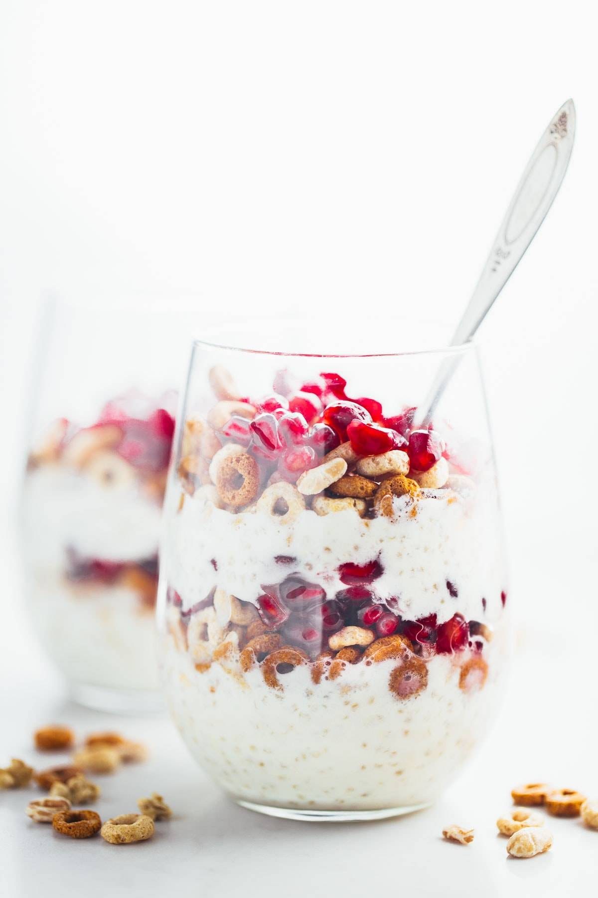 Honey Yogurt Quinoa Parfait in a glass with a spoon.
