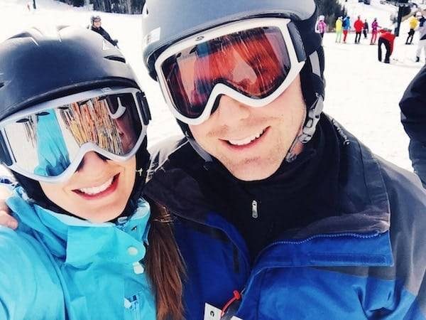 Man and woman wearing ski helmets.