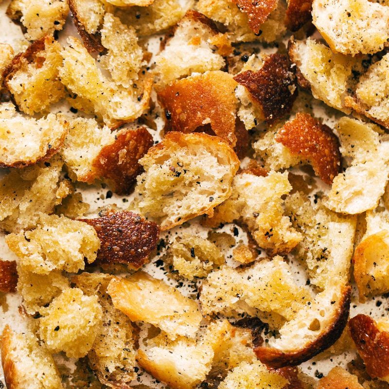 Peppery torn croutons on a sheet pan.