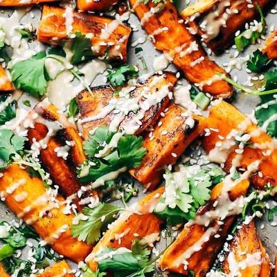 Sesame Roasted Sweet Potatoes baked on a sheet pan.