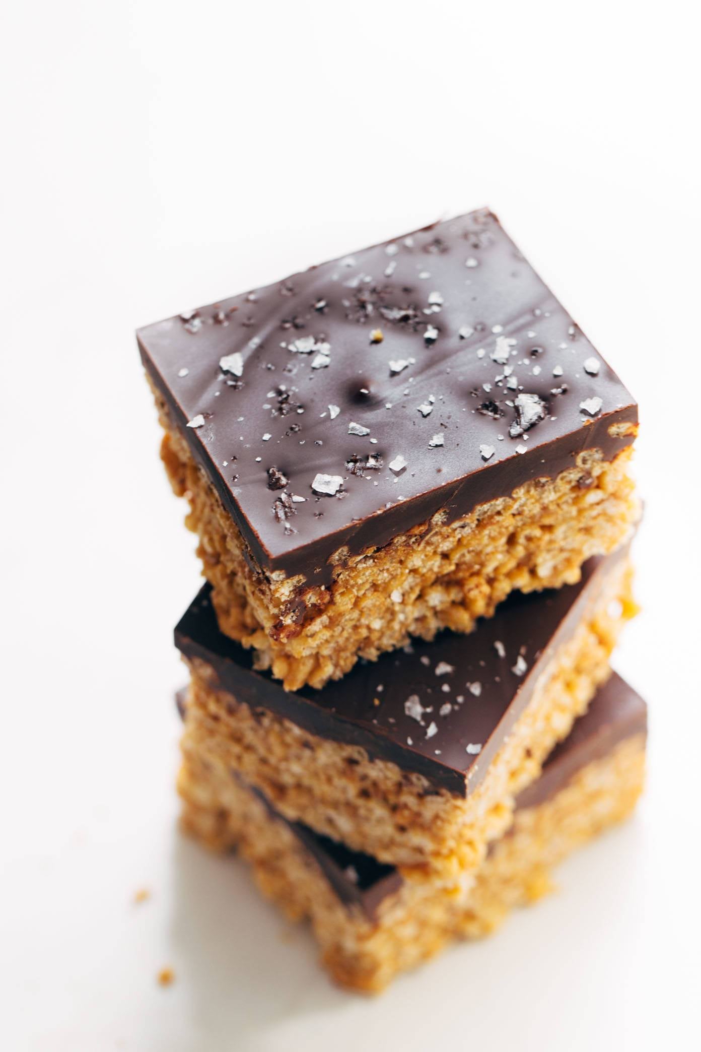 Chocolate-covered peanut butter rice krispie bars stacked on each other.