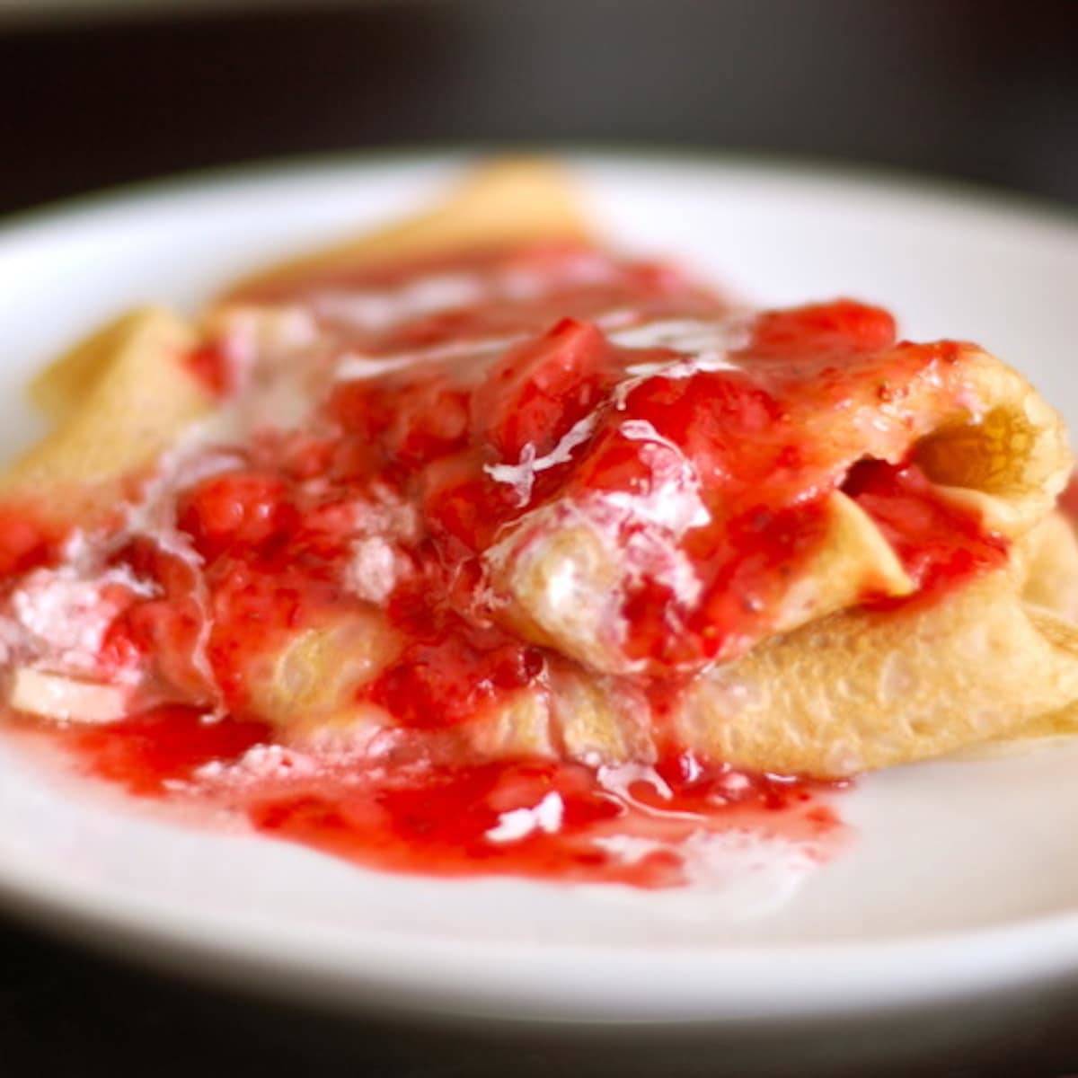 Strawberry blintzes stuffed with creamy ricotta cheese and fresh sweet strawberries.