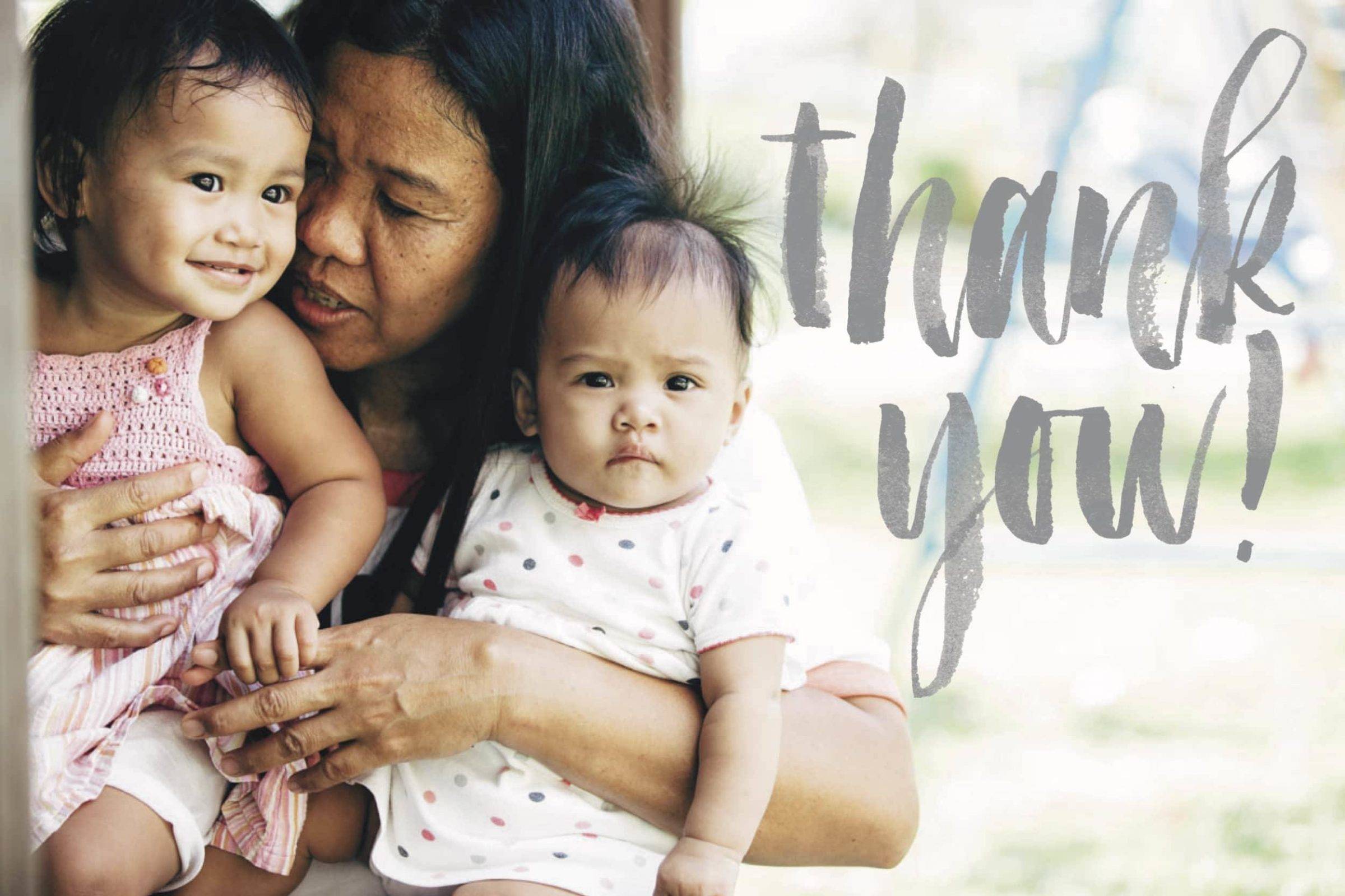 Woman holding two baby girls.