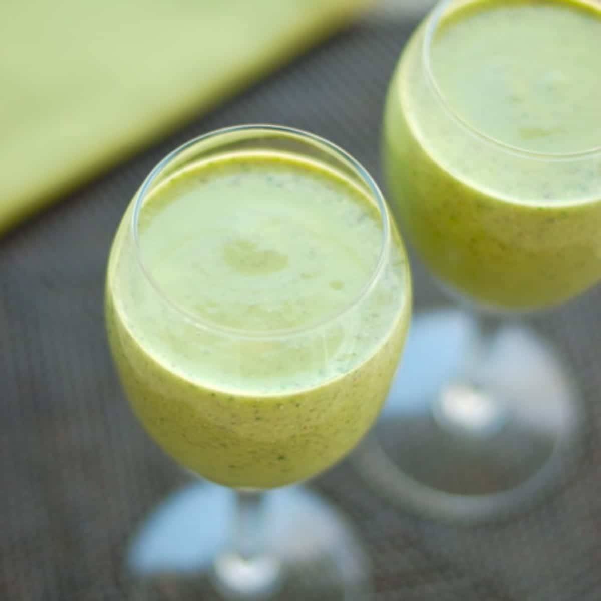 Green monster smoothies in glasses.